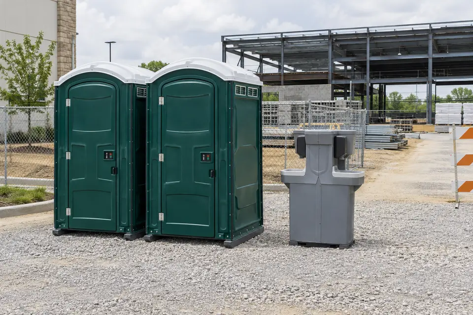 Portable toilets and handwashing beside a construction project
